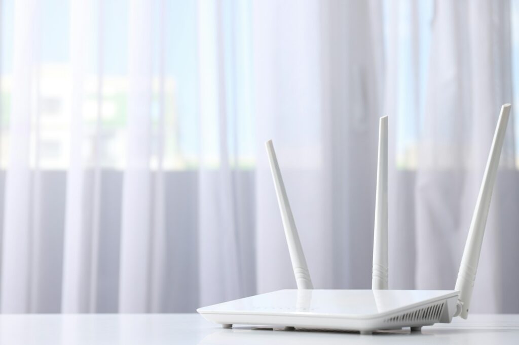 Wi-Fi router on light background, space for text